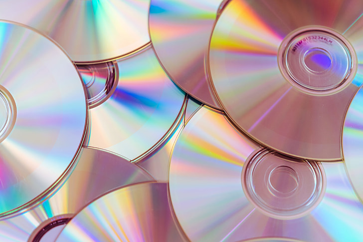 Photo via https://www.pickpik.com/pile-cds-compact-discs-dvds-cd-colorful-78991 under the Creative Commons License

